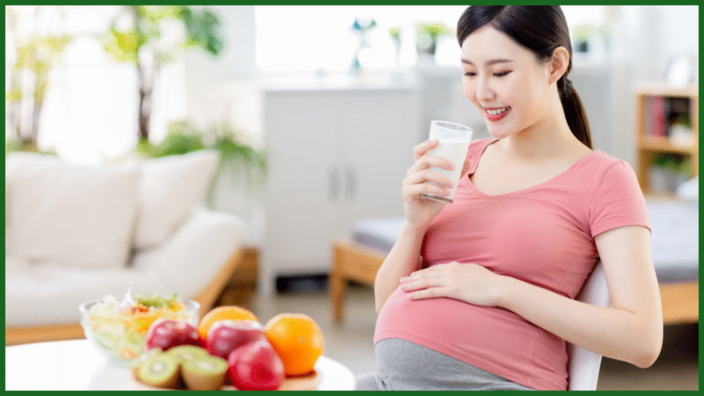 Pregnant woman drinking milk surrounded by fresh fruits, highlighting pregnancy nutrition.
